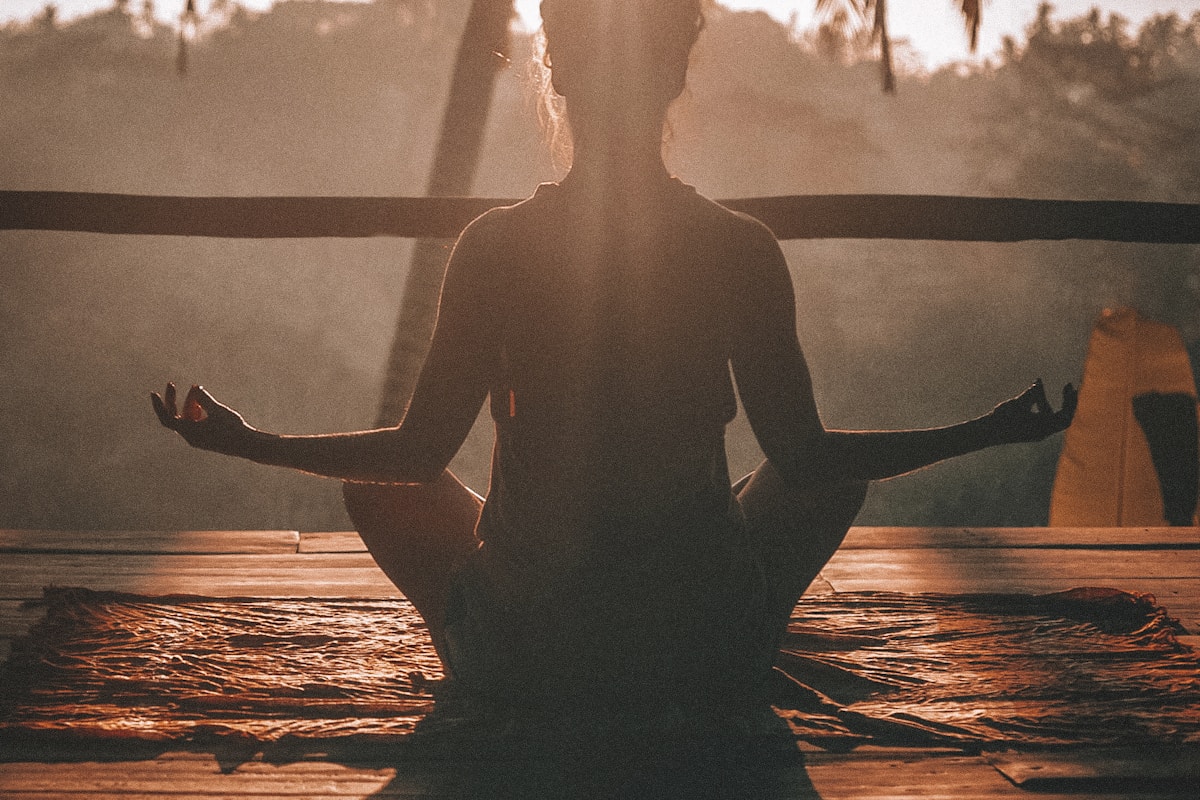 Peaceful meditation setting with morning light filtering through trees